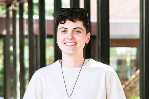 A young person smiling at the camera